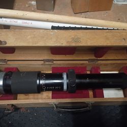 “Nippon Kogaku Japan”, which is the old name for Nikon (used before 1988).

The size, shape, and heavy construction match Nikon’s super-telephoto lens