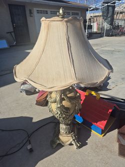 vintage-style table lamp featuring a detailed gold-toned urn base with tassel and rope motifs, similar in style to 19th-century French decorative ligh
