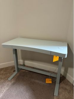 White electric desk with standing desk setting
