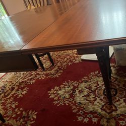 Antique Dining Room Table And Chairs With a Rug 
