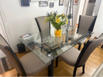 rectangular glass table with 4 upholstered chairs