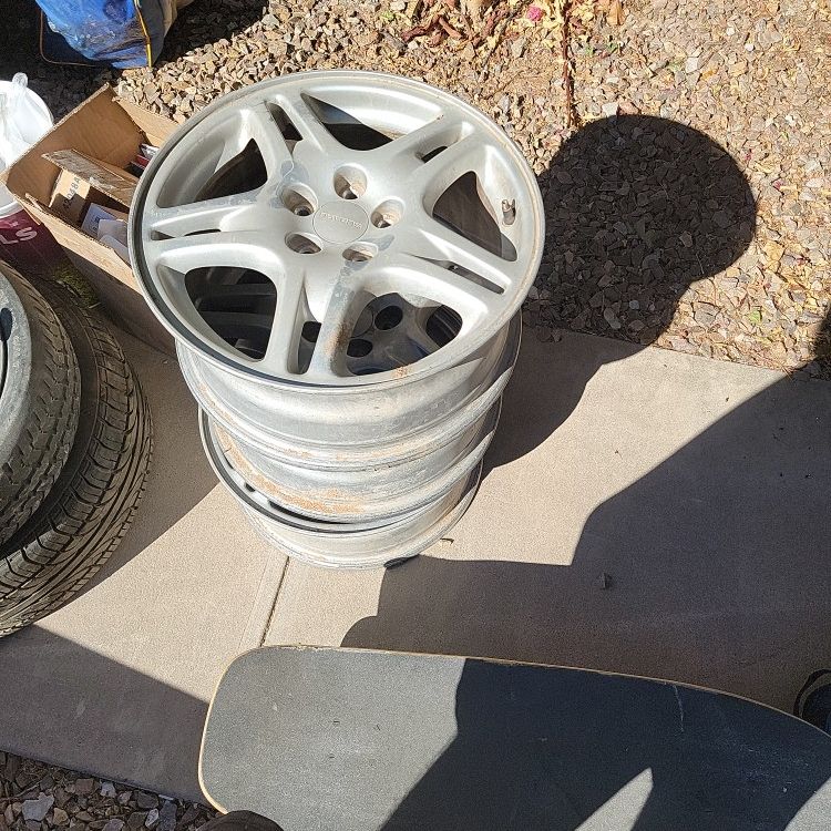 04 SUBARU WRX STOCK RIMS AND ONE BRAND NEW TIRE