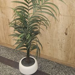 artificial potted palm plant, likely an Areca palm variety. 
It is 