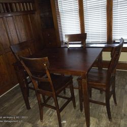 Tall mahogany colored table and chairs