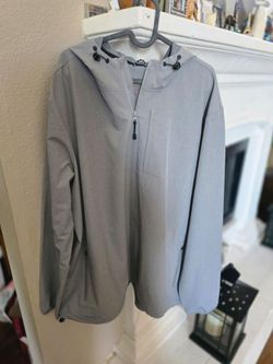 Light gray hooded jacket with full front zipper. Simple, clean design. Soft shell look with zippered chest pocket and side pockets. Lightweight and ve