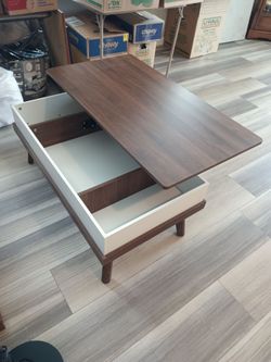 Coffee table with lifting lid for storage.