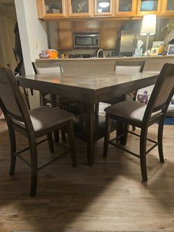High table with lazy Susan and four chairs