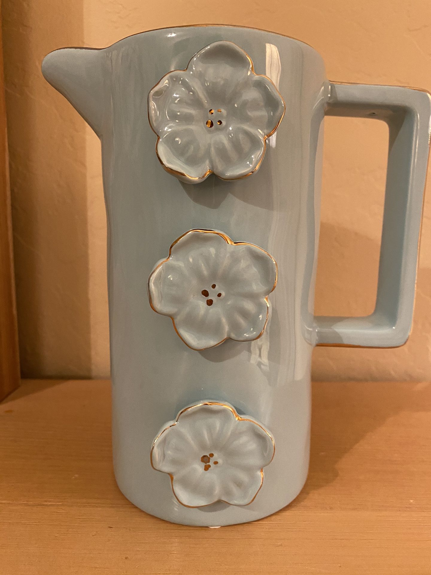 Gorgeous light blue vintage ceramic vase / pitcher. 8 x 6 inches. Raised flowers with gold edges.