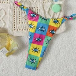 Multi-coloured eye print bikini bottoms #eyebikini Vibrant bikini bottom with eye print. Features blue, yellow, and pink squares. Perfect for a bold b