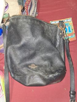 black pebbled leather handbag is a Coach Abby Duffle bag featuring gold-tone hardware.