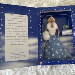 Year 1999 $30.00 Snow Sensation Barbie—a special winter edition doll dressed in a snowy-themed gown with fur trims and a snow globe accessory