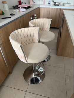 2 beige adjustable  chairs