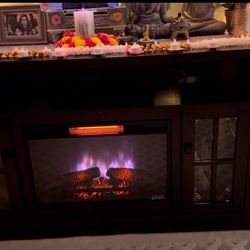 Cherry real wood  rooms to go Electric fire place/TV stand  it will fit 65 inch tv ,dimensions are 59 x 15.5 x 34 . In person super beautiful then pic
