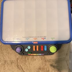 Fisher-Price Music Creator toy with colorful lights and interactive buttons. It's designed for exploring sound and colors! This toy is great for littl