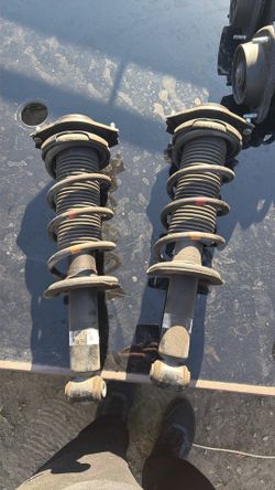 The part number 20365CA100 (also referenced as SU003-05258 or SU003-04147) is a genuine OEM rear shock absorber (and strut assembly) for the Subaru BR