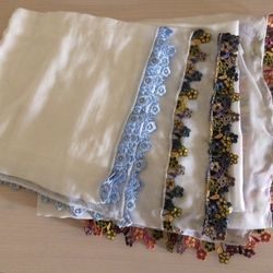 three embroidered flower edged scarves