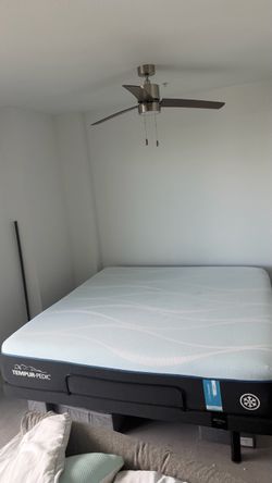 Pre-owned king-size Tempur-Pedic bed, including its remote control.