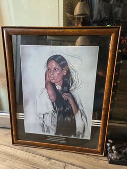 Painting of a Native American woman by artist Penni Anne Cross, dated 1981 and set within a textured wooden frame.
