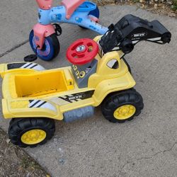 2 Riding Toys. Bike & Yellow Truck Doesn't Have A Seat Or Claw. Just Cheap. West Or East