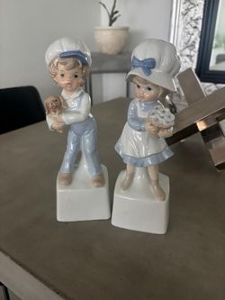 Vintage Berman and Anderson porcelain girl and boy music box figurines hand painted with a blue and white color scheme. $80