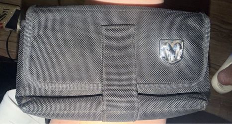 :Barely used OEM black nylon Dodge Ram owners manual case featuring the distinctive chrome Dodge Ram's head logo on the front flap. located off lake m