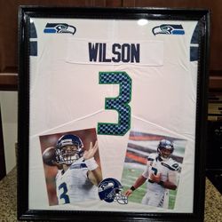 RUSSELL WILSON WITH THE SEATTLE SEA HAWKS CUSTOM STITCHED JERSEY.