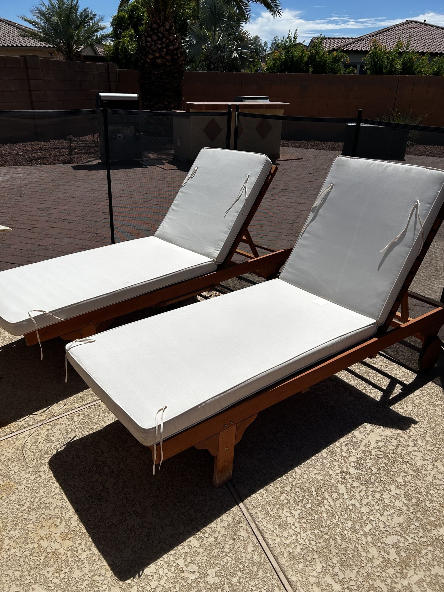Two Wooden Lounge Chairs With Cushions
