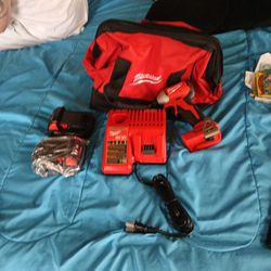 Milwaukee impact drill,2 batteries, charger and the milwaukee bag brand new
