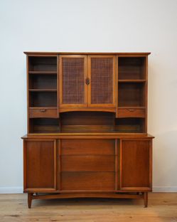 Mid-Century Modern two-piece hutch and buffet set, featuring walnut wood and cane detailing on the cabinet doors