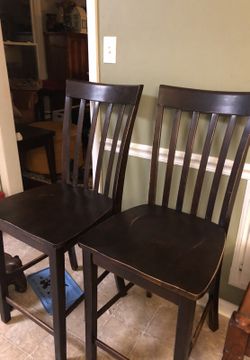 Two bar chairs or stools dark wood