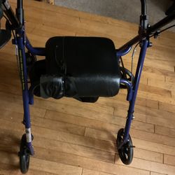 A Folding Black Walker That Can Be Folded And Put Away When Not Using ( There’s A Piece Of The Leather On The Chair Ripped A Little) NO SHIPPING)