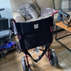 Transport wheelchair with hand brakes in swing out foot stand