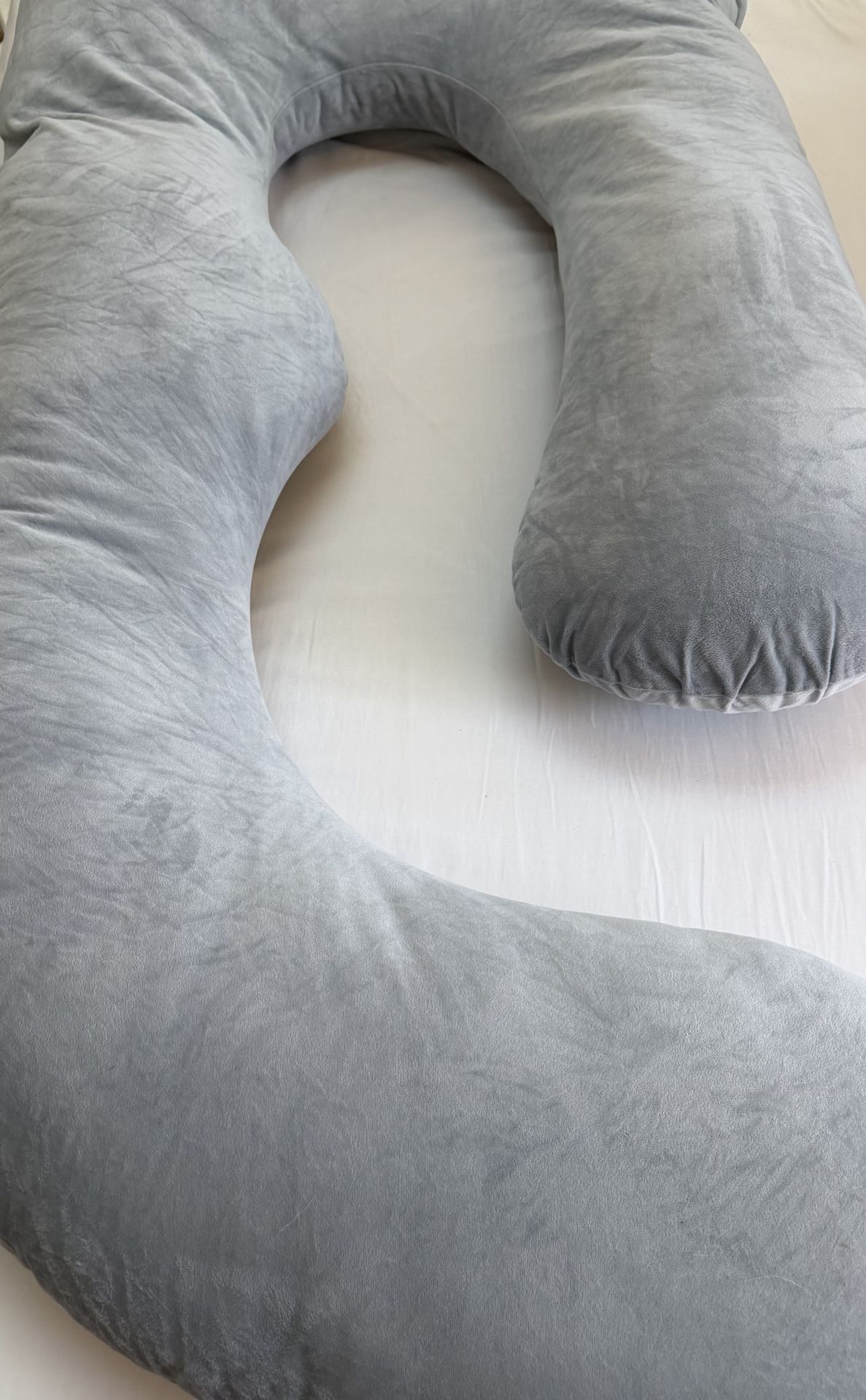 Momcozy brand body pillow for women or men. Comfortable machine washable cover