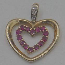 10KT YELLOW GOLD 2 GRAMS  HEART SHAPED PENDANT  W DIAMONDS AND RUBIES GOOD CONDITION.  883410-2 