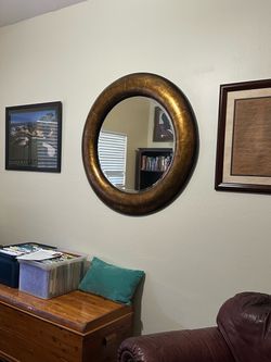 Large round framed beveled mirror