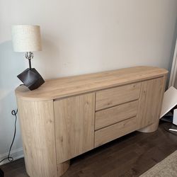 Oval wood sideboard with doors and drawers