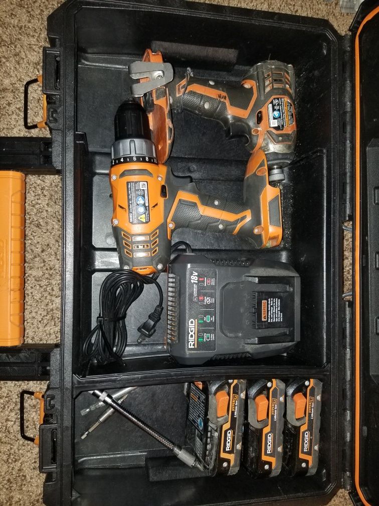 RIDGID HAND TOOLS, 1 IMPACT DRILL, 1 DRILL WITH 18V BATTERIES, CHARGER AND HARD CARRY CASE.