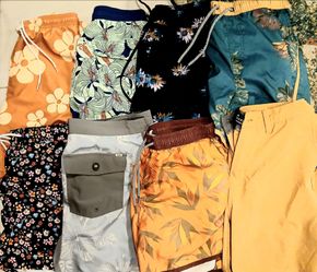 eight pairs of men's swim trunks and board shorts