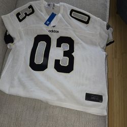 White Adidas sports jersey with black numbers.