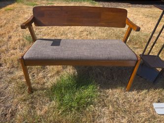 Wooden bench with padded seat