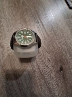 Dark brown watch with silver clock and green background good quality and very comfortable