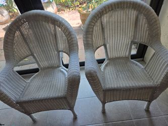 2 Wicker (plastic) chairs for outside or inside.