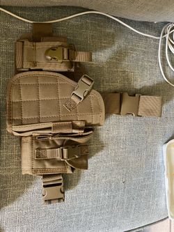 Holster with ammunition pockets