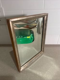 This antique wood framed beveled edge mirror measures 11.25”