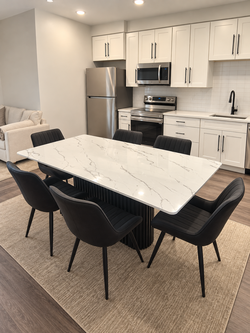 Modern dining table with six black chairs