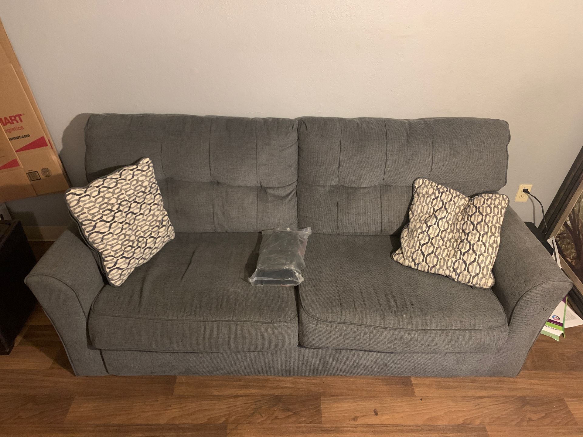 Grey sofa with two pillows
