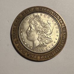 Encased is a Original 1889 Silver Dollar Advertising Coin for Buick. Outer Ring Says Its The Best Buick Yet