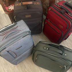 lots of soft and hard shell carry on suitcases