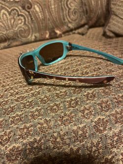 Vintage Oakley Disobey sunglasses, model 05-321, featuring a distinctive brown tortoise shell frame with teal interior