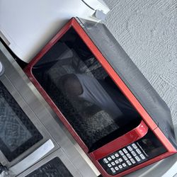 red Hamilton Beach countertop microwave oven.
